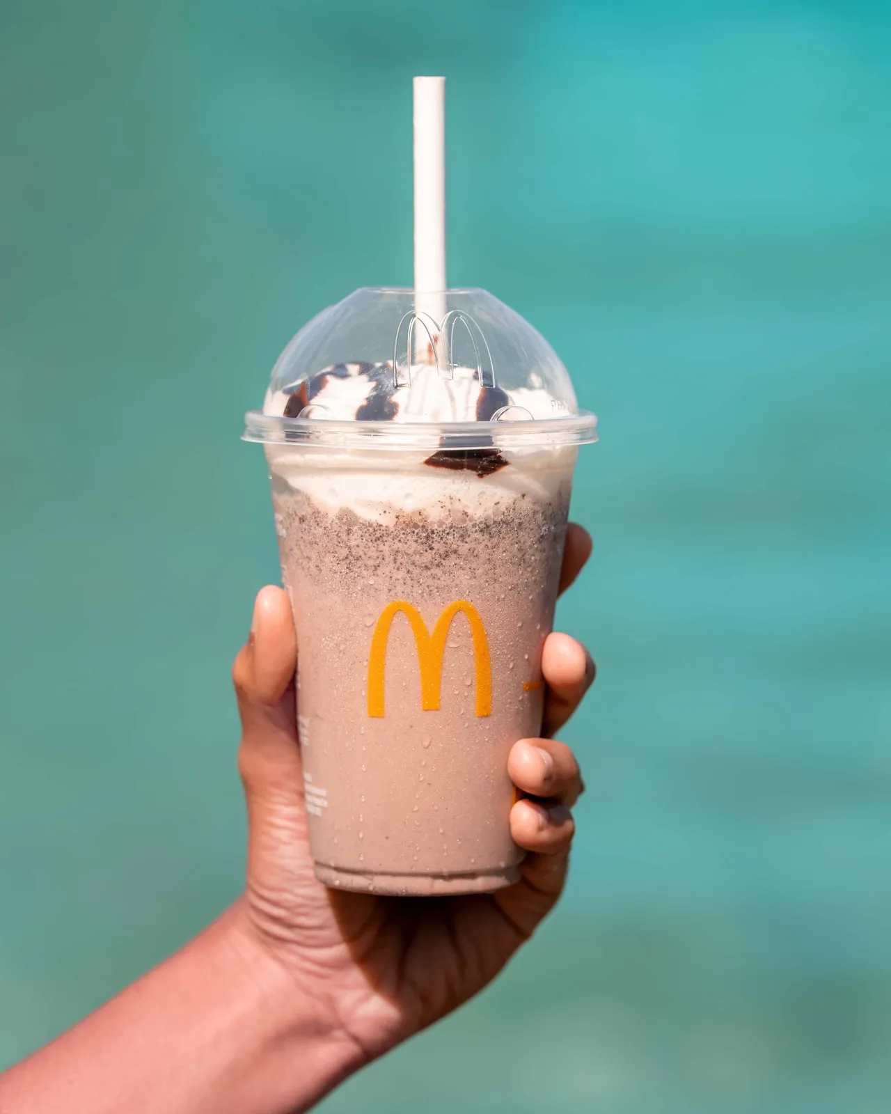 McDonald’s drink held against turquoise