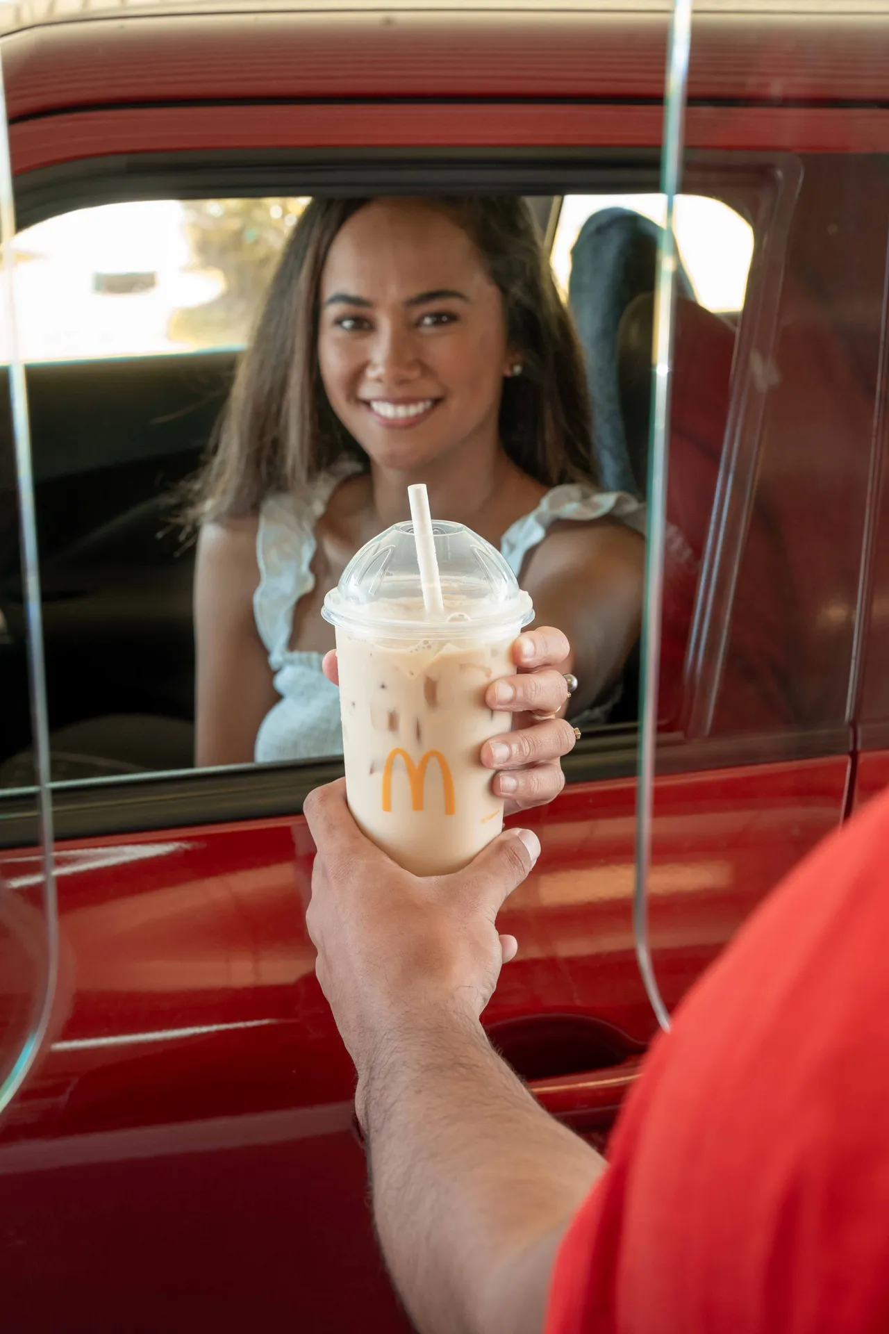 Drink presented at a red car window
