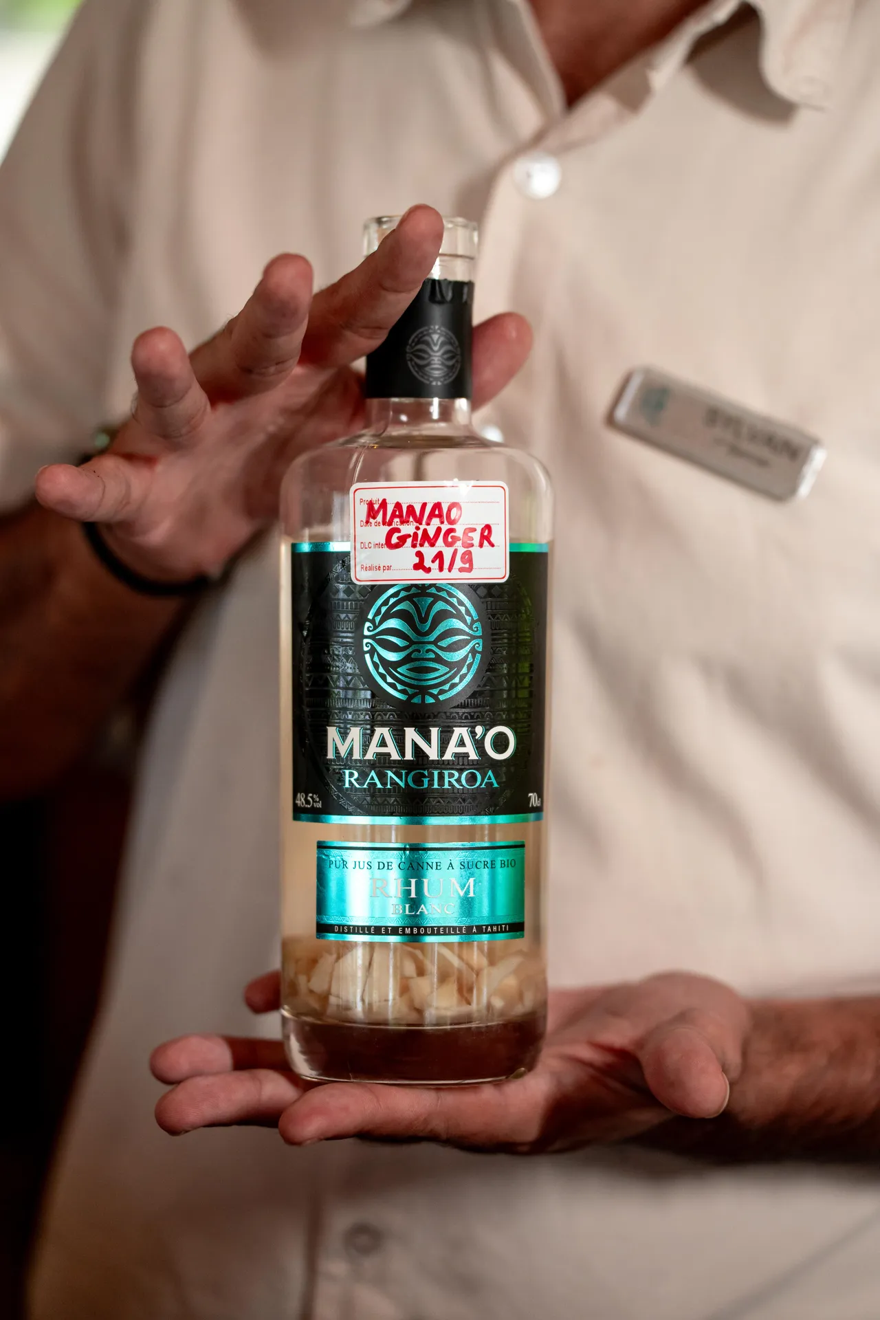 Spirits bottle presented by hand