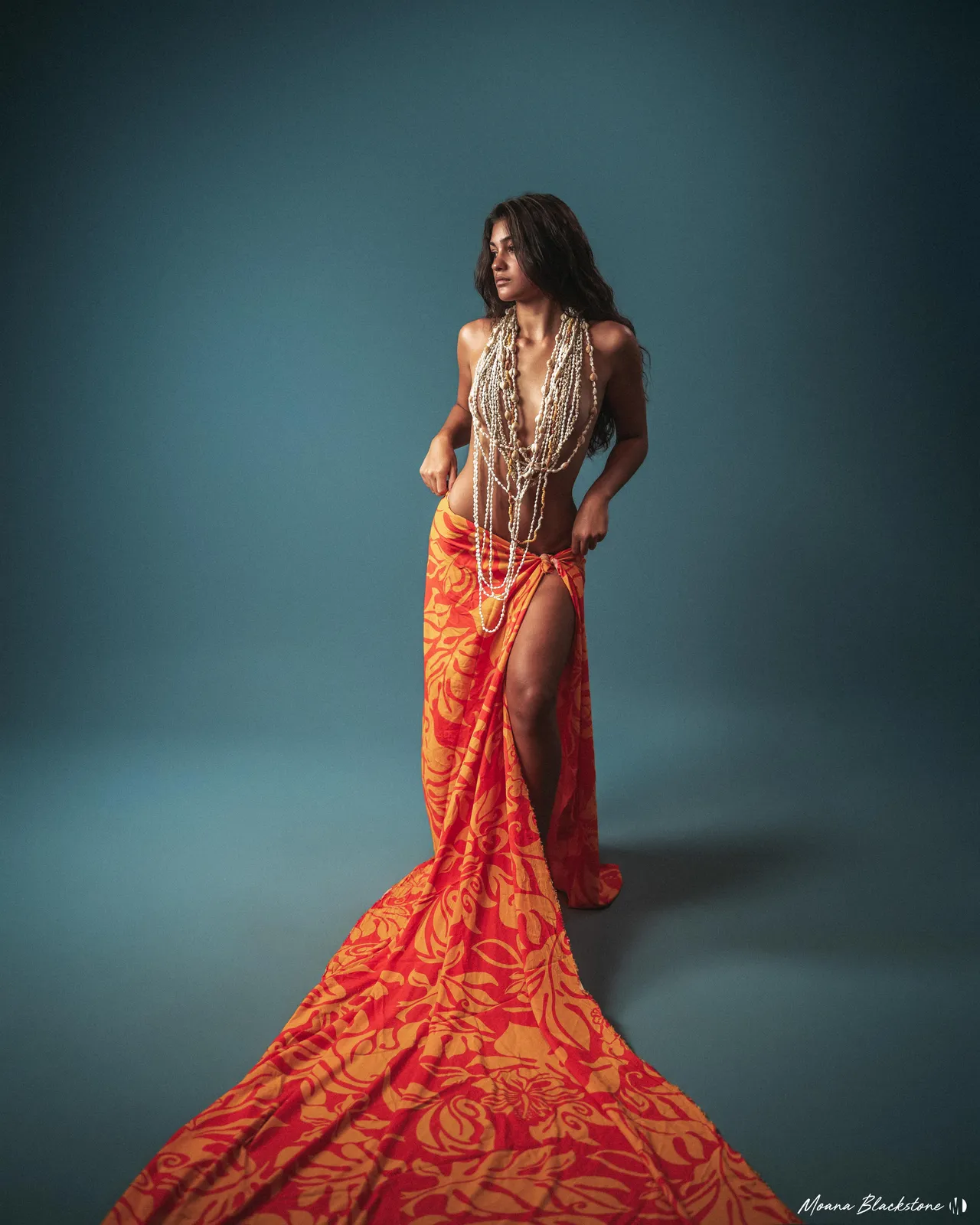 Long patterned dress against a blue backdrop