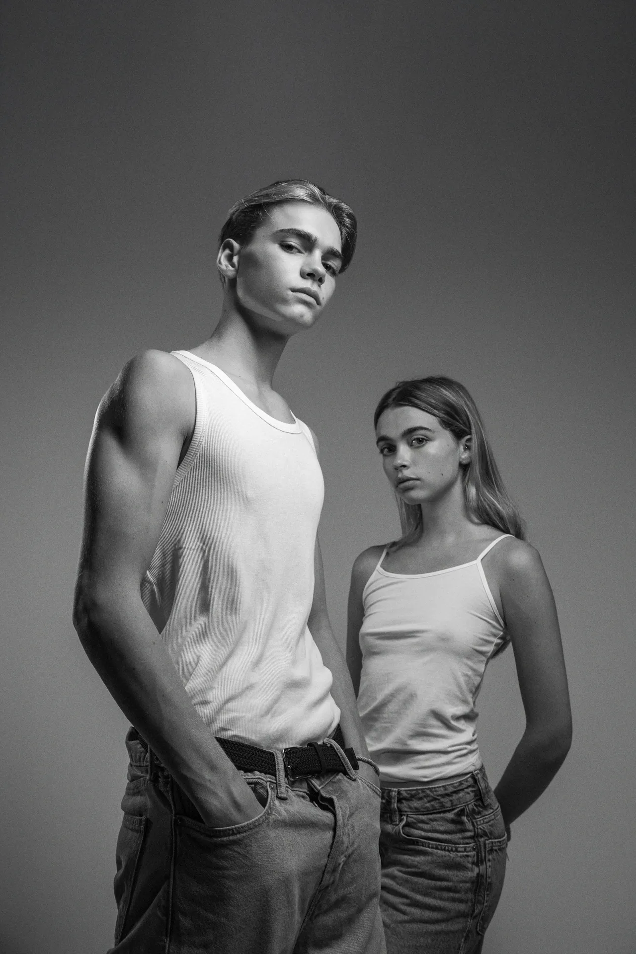 Black-and-white portrait of a duo in tank tops