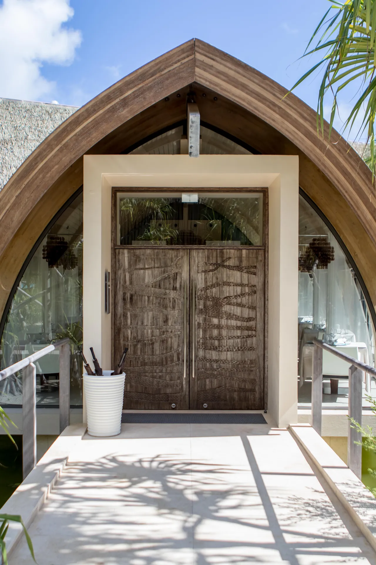 Bungalow entrance beneath a wooden roof
