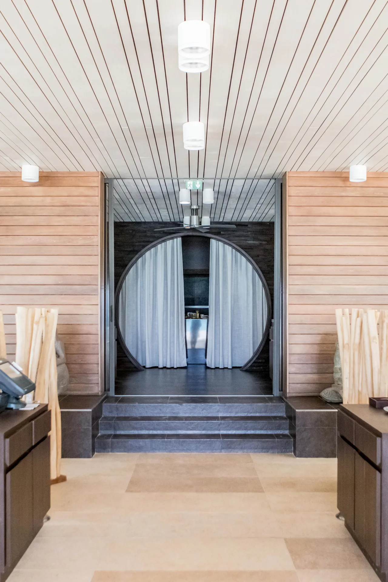 Wood-lined interior with a round doorway